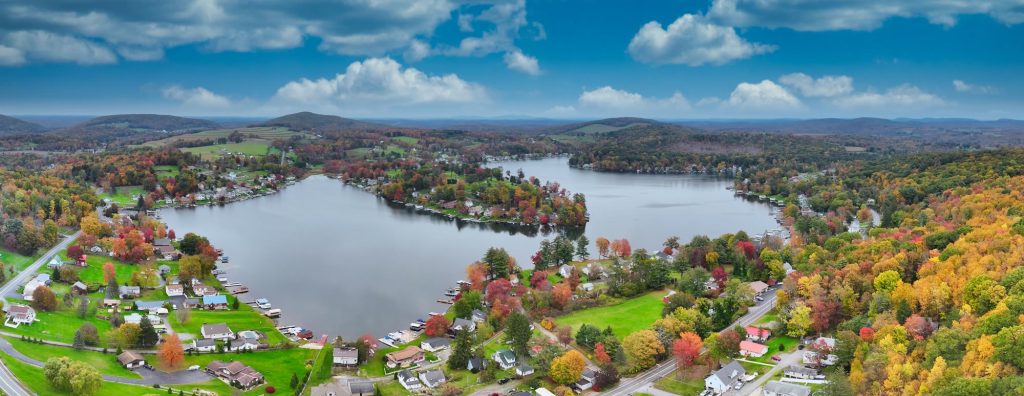 Aerial panorama of a lake community surrounded by fall foliage in Northeastern Pennsylvania