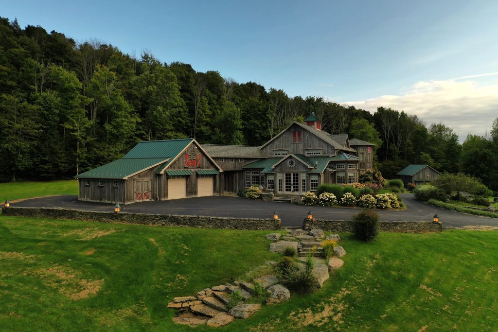 Drone photo of a stone and timber country home with landscaped gardens, Northeastern Pennsylvania