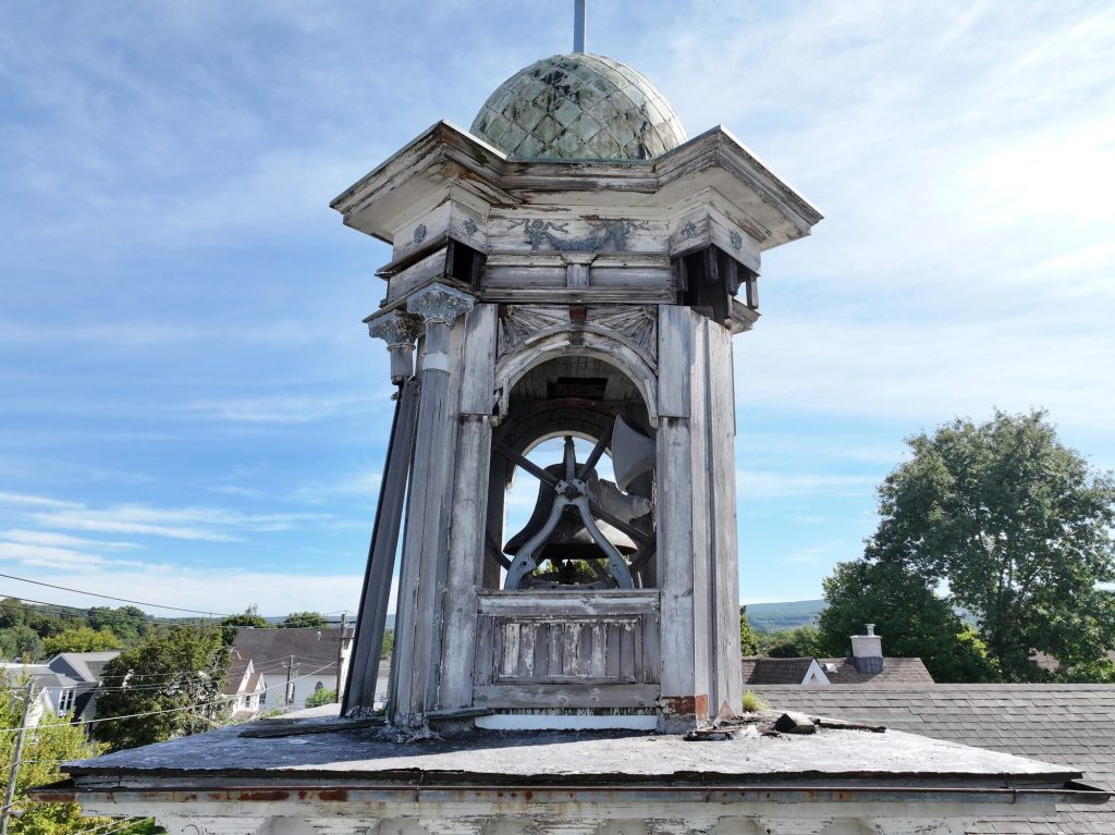 Close-up drone inspection photo of a church bell tower