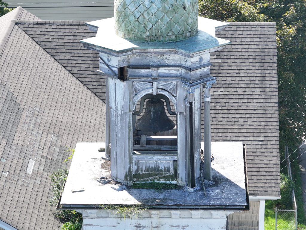 Close-up drone inspection photo of church steeple detail