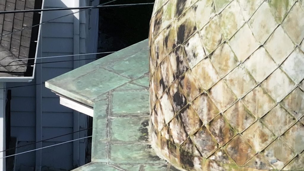 Close-up drone inspection photo of church steeple detail